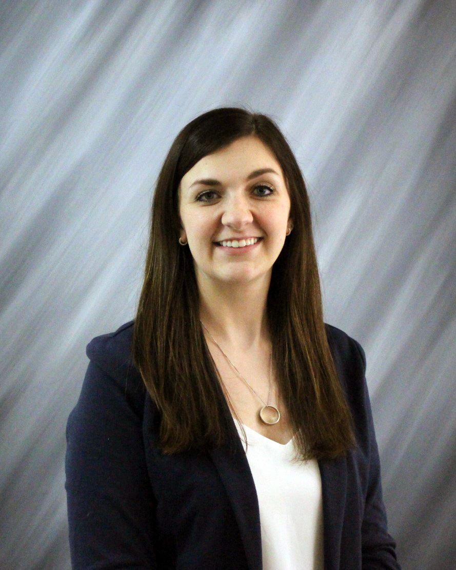 White female in business professional clothing. 
